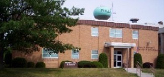 The front of the Sheriff Department building which is shaded by a large tree